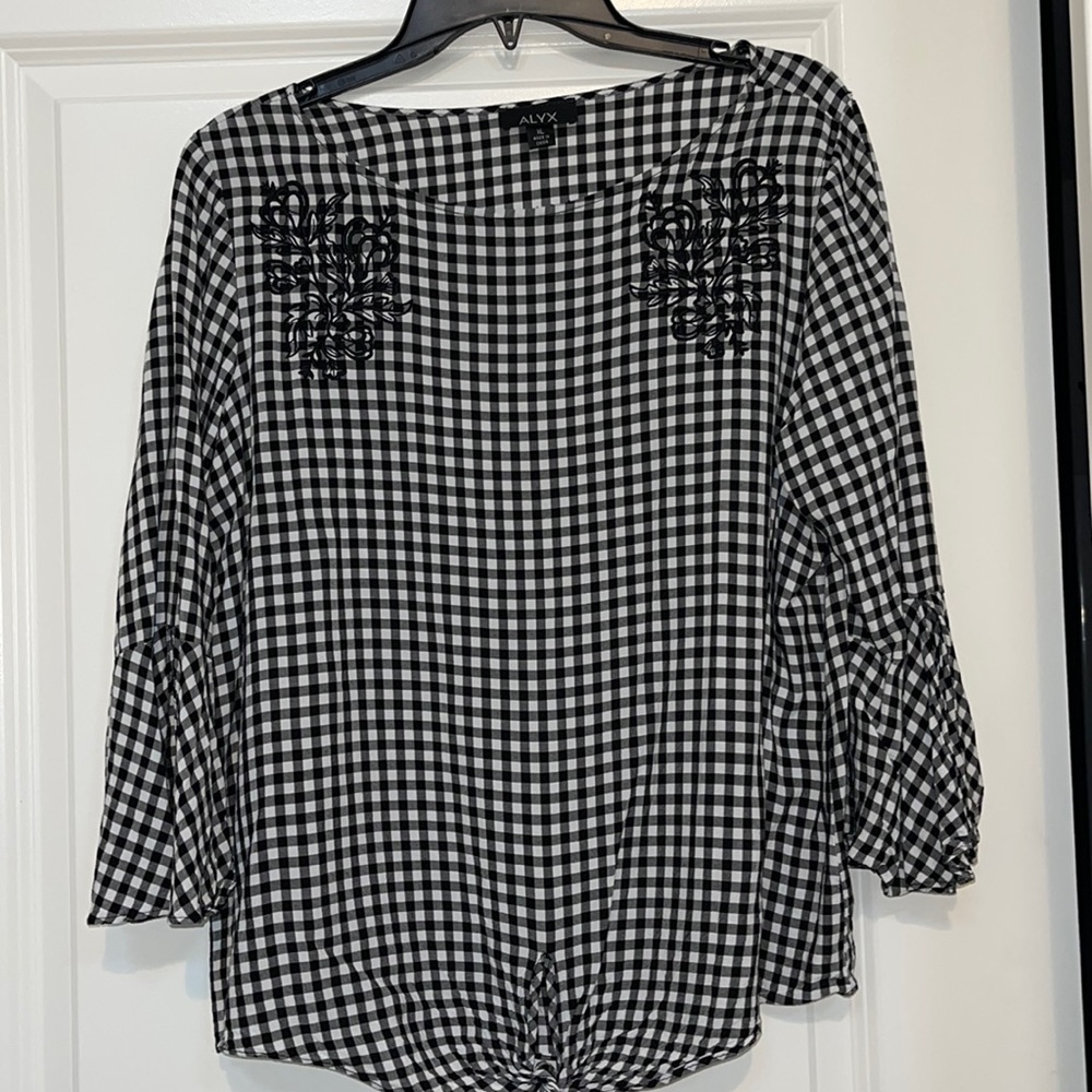 Black blouse/white checks.  Cute flared sleeves and tie at waist.